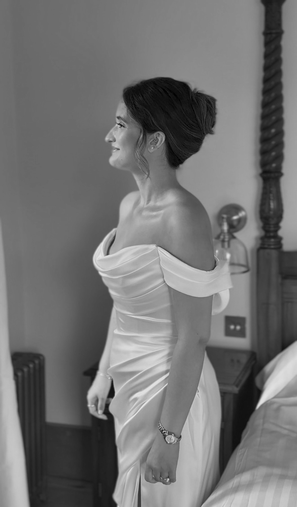 Bride in off-the-shoulder dress getting ready
