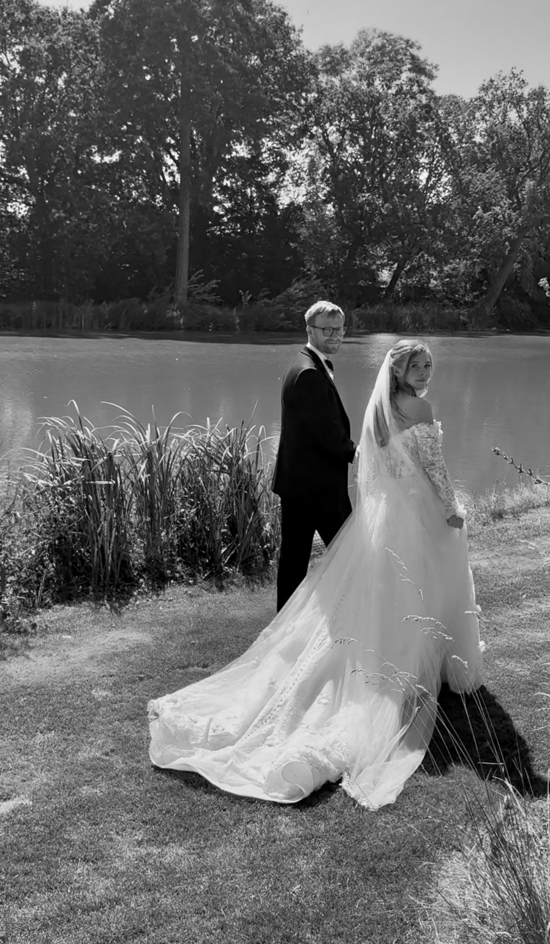 Couple by the lake looking back toward the camera