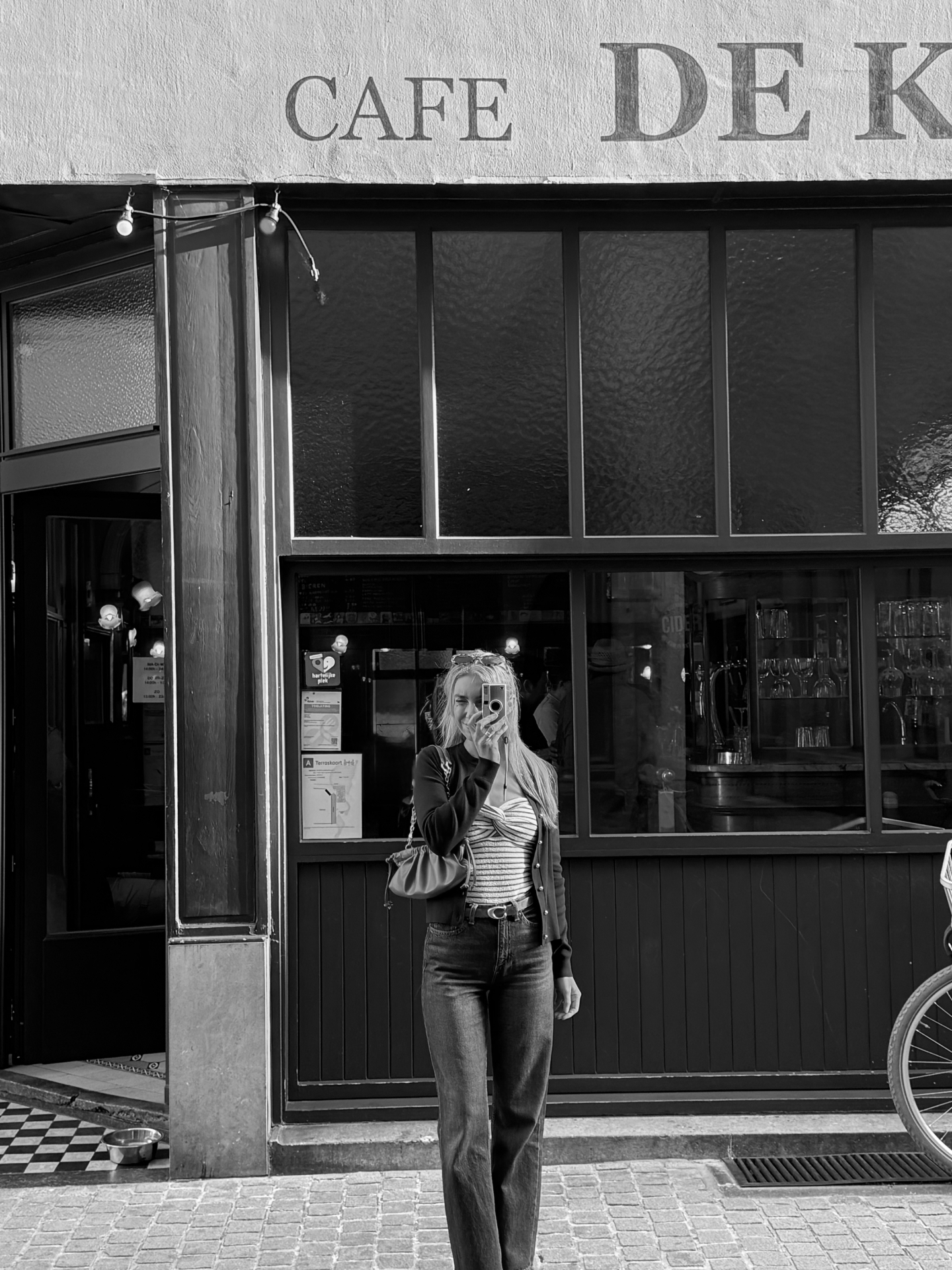 Hannah taking a mirror selfie outside Café De Kat